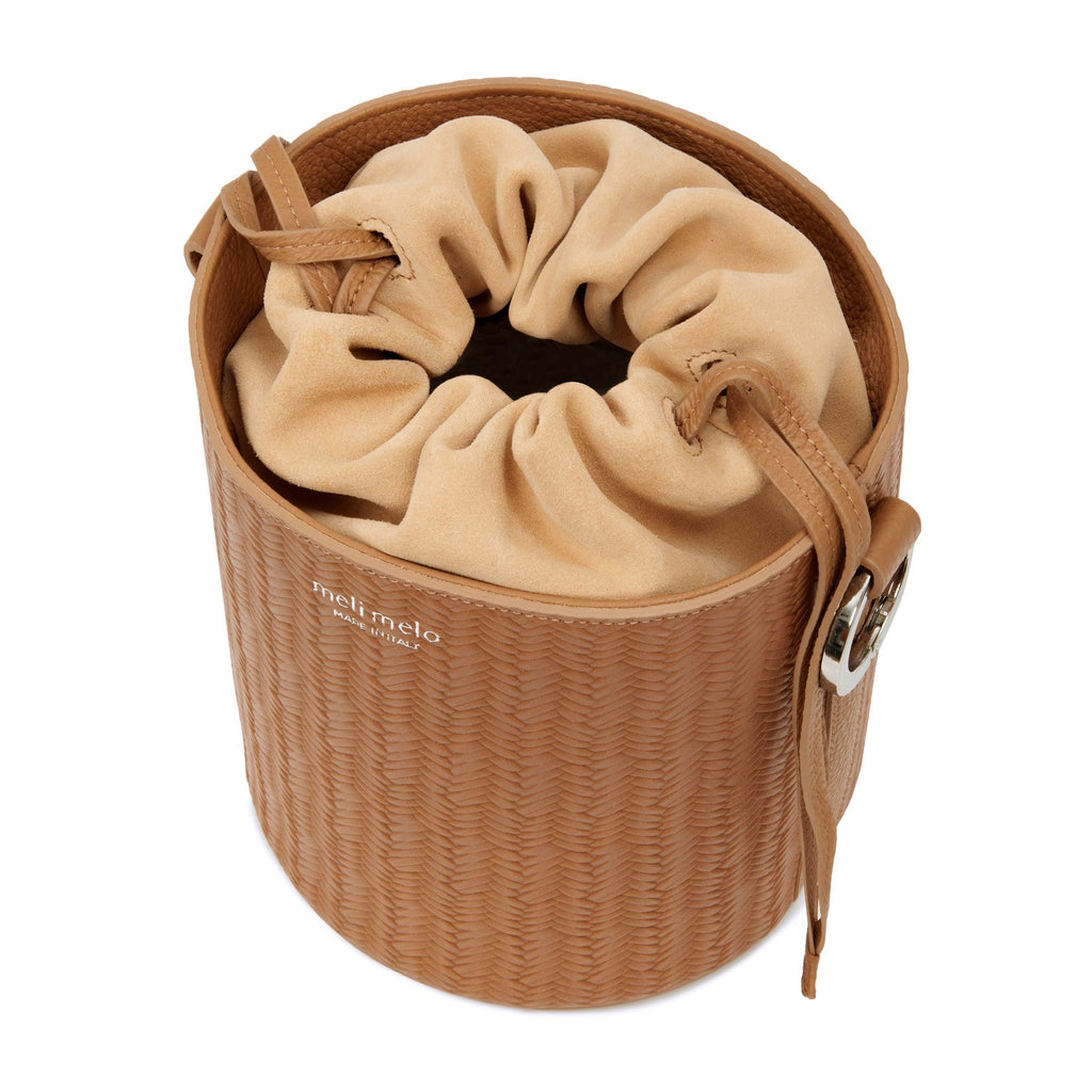 meli melo - Santina bucket bag in tan - recreating a woven basket 🧺 feel  in our signature 🇮🇹 leather • shop it in tan, black and dark tan