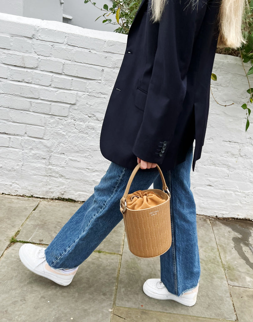 meli melo - Santina bucket bag in tan - recreating a woven basket 🧺 feel  in our signature 🇮🇹 leather • shop it in tan, black and dark tan
